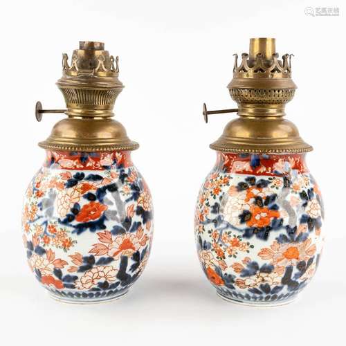 A pair of Chinese export Imari vases, rebuilt as oil lamps. ...