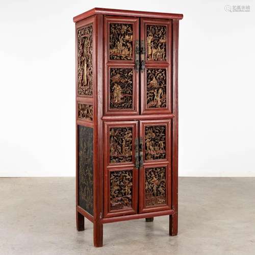 A Chinese cabinet with finely sculptured lacquered and gilt ...