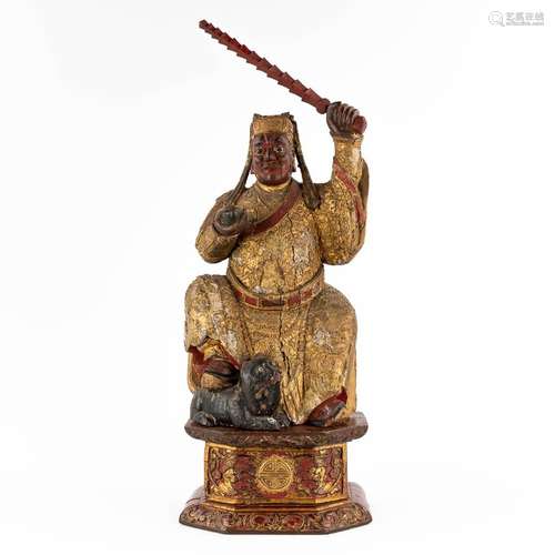 A Chinese antique figurine of a warrior, gilt and polychrome...