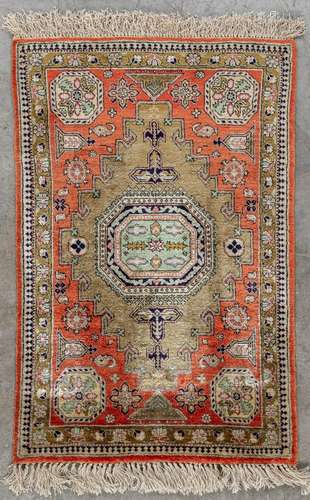 A small Oriental hand made carpet, silk, Ghoum. (D:82 x W:54...