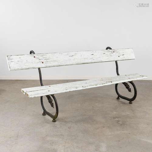 An antique garden bench, wood and metal decorated with drago...