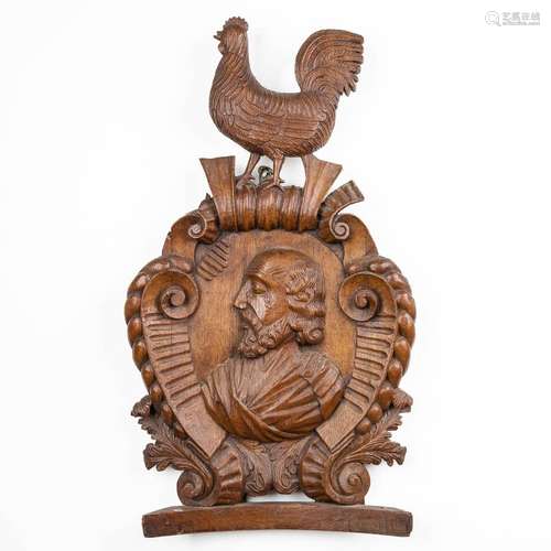 an antique wood sculpture medallion with a portrait and a ro...