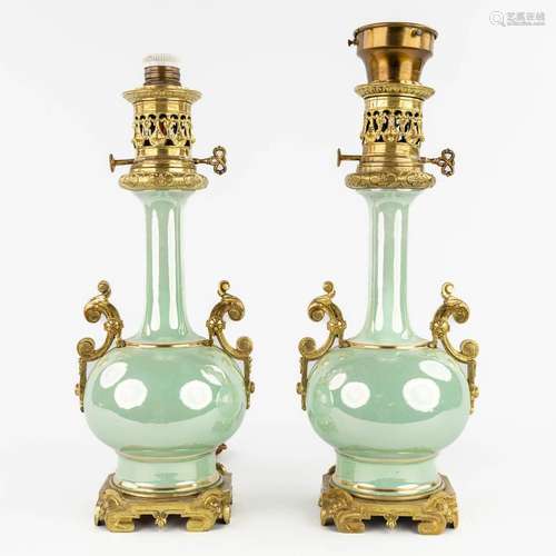 A pair of oil lamps, earthenware with a luster glaze and mou...