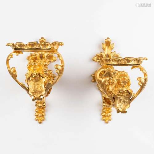 A pair of wall lamp or candle holders, lions with a heraldic...