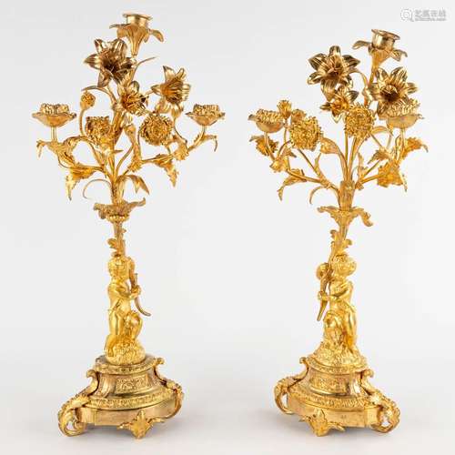 A pair of candelabra with putti, gilt bronze. Circa 1900. (W...