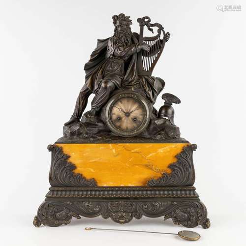 An antique mantle clock 'Bragi with a harp' patinated bronze...