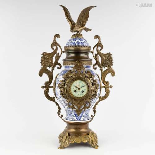 A mantle clock, Delfts faience mounted with bronze and an ea...