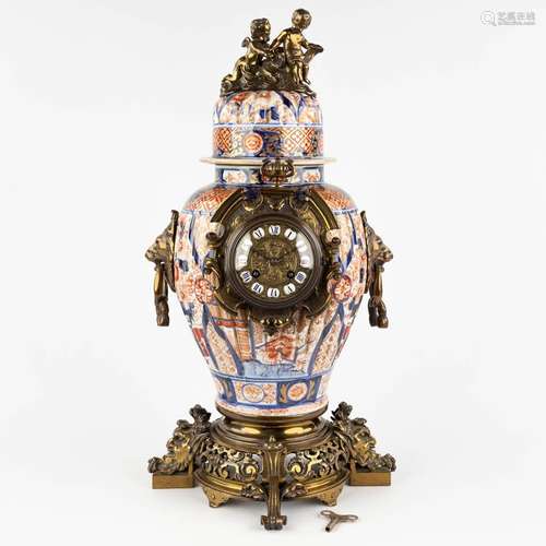 A mantle clock, Japanese Imari porcelain mounted with bronze...