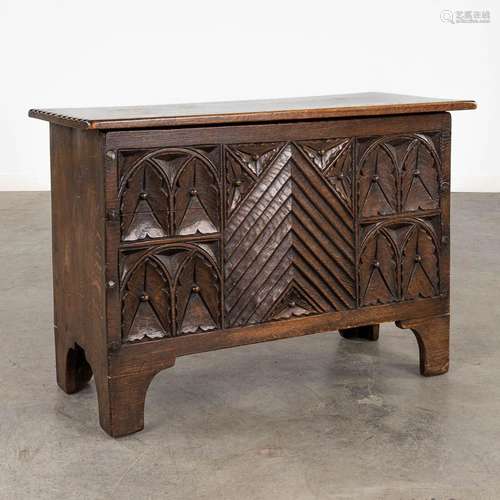 An chest, sculptured panels in a Gothic-revival inspired sty...