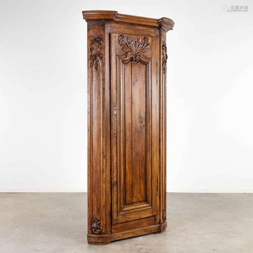 An antique corner cabinet, wood sculptures Louis XV. 19th C....