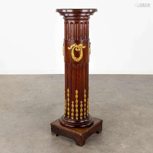 A pedestal, mahogany mounted with bronze in Louis XVI style....