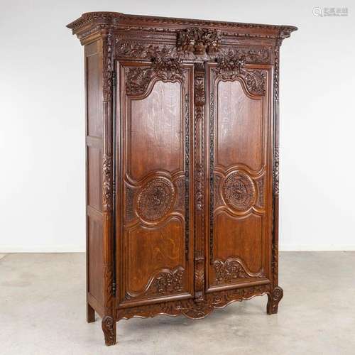 A richly sculptured and antique Normandy high cabinet, Armoi...