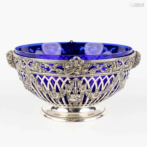 A bowl, silver and blue glass, decor of ram's heads and garl...