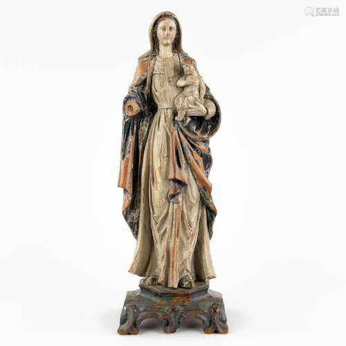 An antique wood-sculptured figurine of Madonna with Child, p...