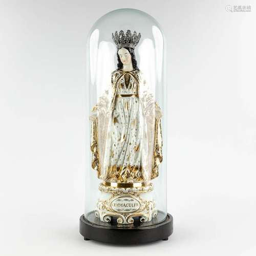 a large figurine of Madonna standing under a glass dome. Vie...