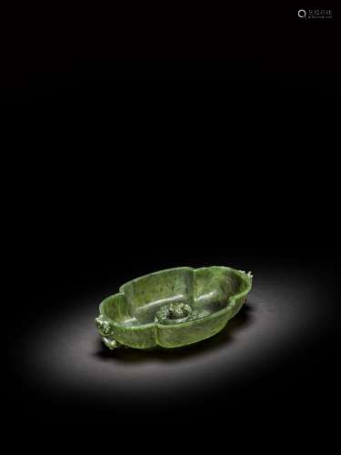 <br />
A spinach-green jade 'dragon' lobed washer, Qing dyna...