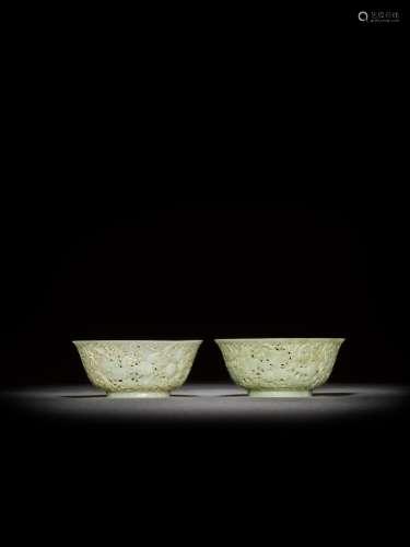 <br />
A pair of reticulated pale celadon jade 'gourd' bowls...