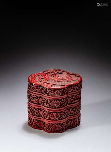 <br />
A carved cinnabar lacquer three-tiered box and cover,...