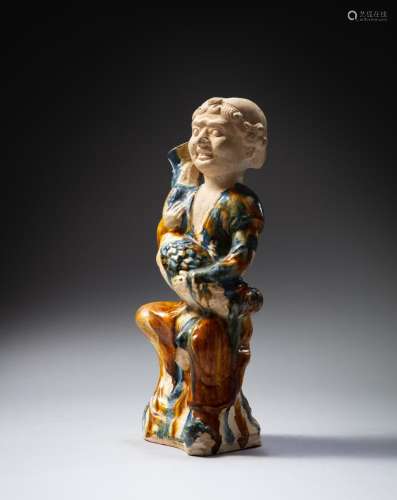 <br />
A sancai-glazed figure of a foreigner holding a 'goos...