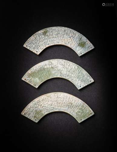 <br />
Three archaistic Han-style celadon jade semi-circular...