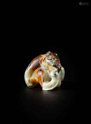 <br />
A celadon and russet brown jade ‘bear’ carving, Proba...