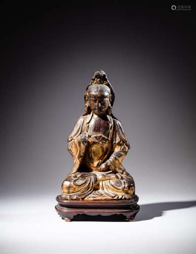 <br />
A gilt-lacquered wood figure of Guanyin, Qing dynasty...
