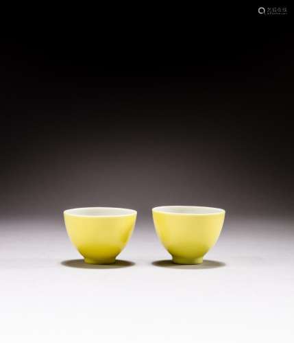 <br />
A pair of lemon yellow-glazed cups, Marks and period ...