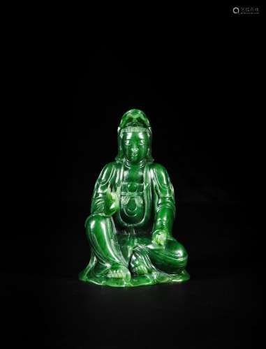 <br />
A spinach-green jade figure of a seated Guanyin, Qing...