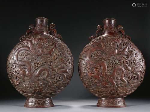 A pair of old agarwood carved dragon pattern flat belly bott...