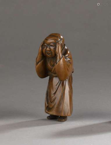 Netsuke en bois représentant un garçon masqué, Japon, XIXe s...