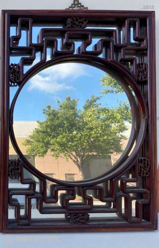 A WOODEN FRAMED MIRROR