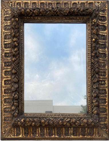 A WOODEN FRAMED MIRROR