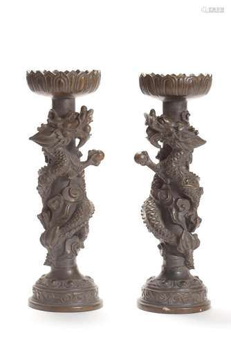 A PAIR OF BRONZE DRAGON CANDLE STICKS