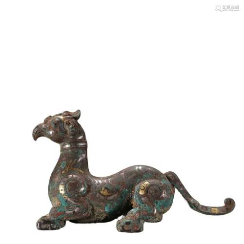 A BRONZE GOLS AND SILVER INLAY MYTHICAL BEAST ORNAMENT