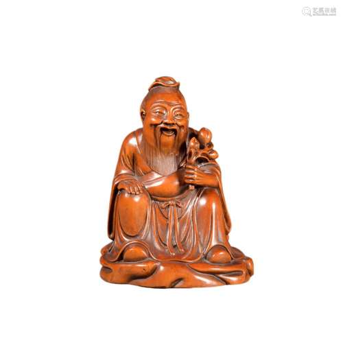 A BOXWOOD CARVED FIGURE OF DONGFANG SHUO