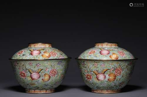 A pair of cups with enamel painted melons and lids on a copp...