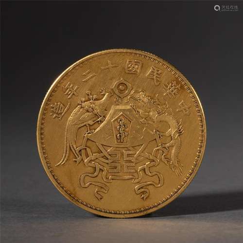 A CHINESE SILVER GILT COIN