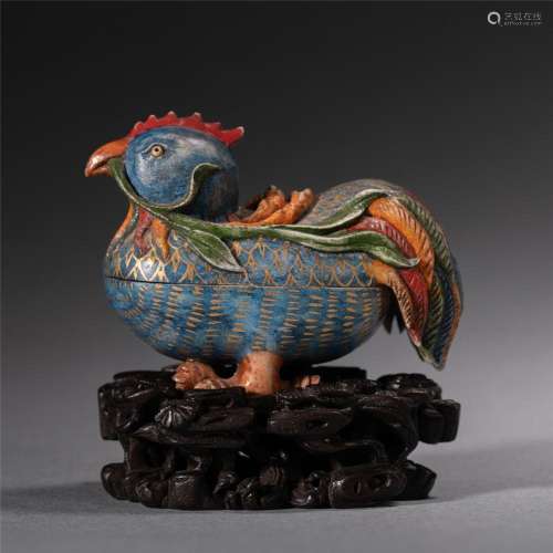 A CHINESE CARVED AND PAINTED STONE CHICKEN WITH REED