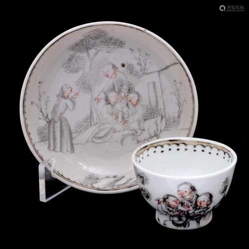 A MINIATURE CUP AND SAUCER