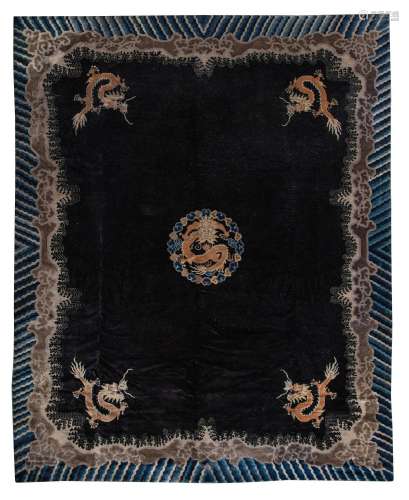 A large Chinese 'Dragon medallion' black wool rug, late Qing...