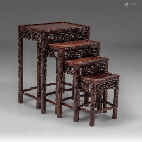 A set of four Chinese carved hardwood nesting tables, talles...