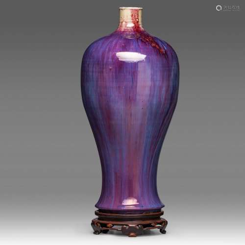 A tall Chinese flambe-glazed meiping vase, fixed on a wooden...