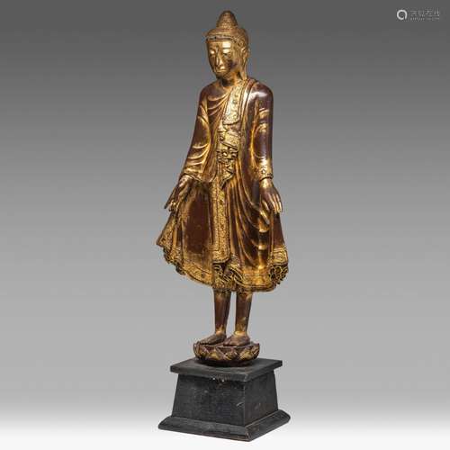 A Burmese lacquered standing Buddha on a lotus base, late 19...