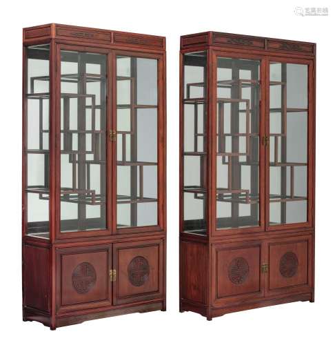 Two Chinese hardwood display cabinets, the doors with glass,...