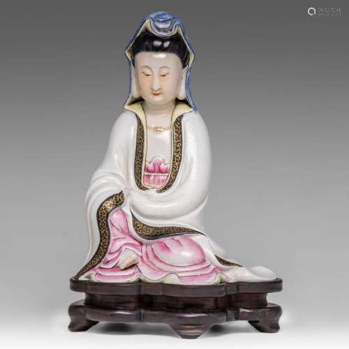 A Chinese famille rose and sgraffito figure of seated Guanyi...