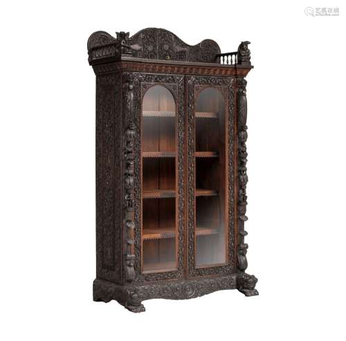 A richly carved exotic hardwood Anglo-Indian display cabinet...
