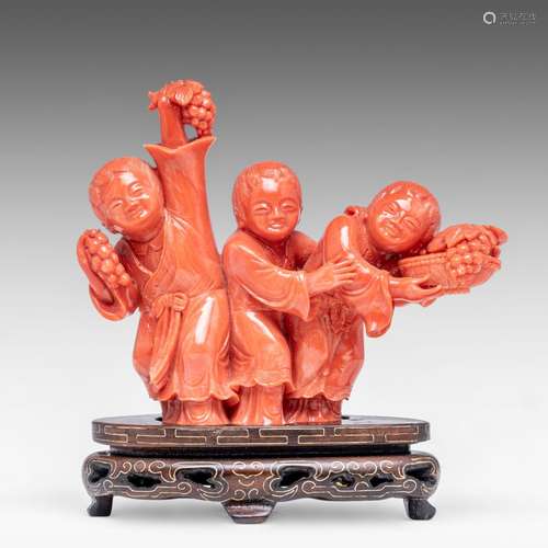 A Chinese carved coral group, depicting three playful boys, ...