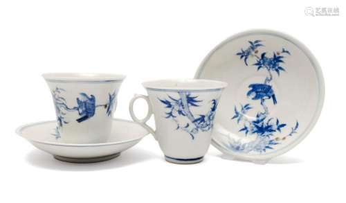 A pair of blue and white cups and saucers with underglaze co...