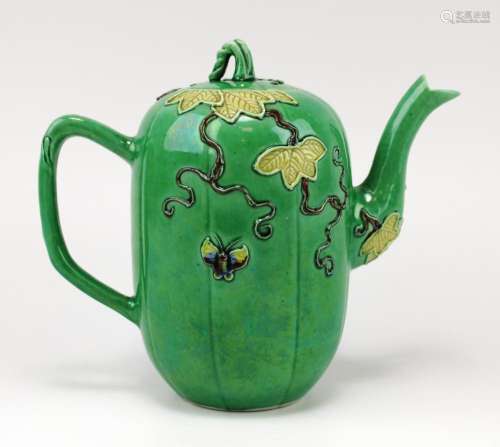 A green glazed melon or gourd-shaped teapot with relief deco...