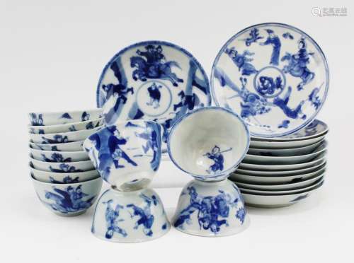 Twelve blue and white cups and saucers with figures